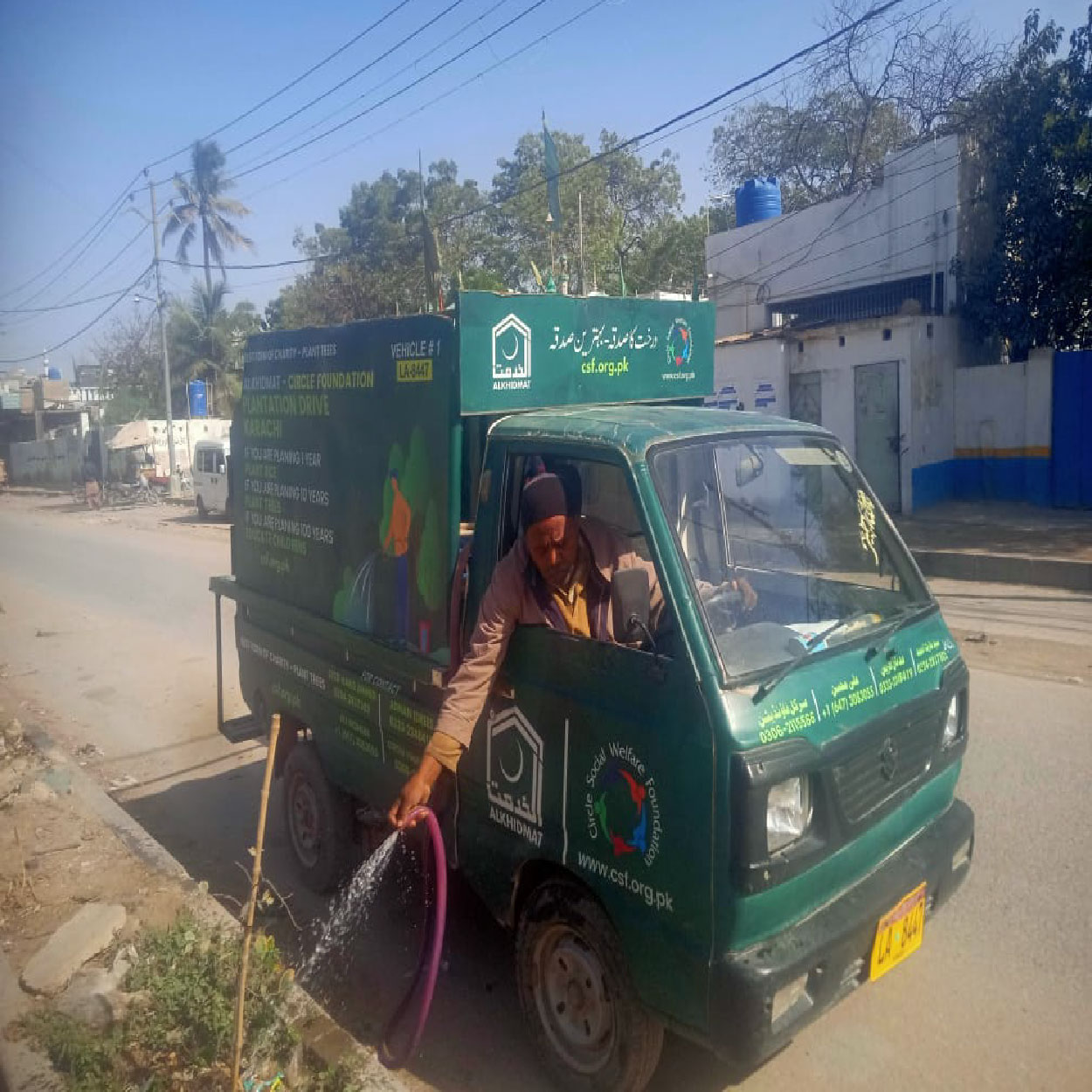 Circle Social Welfare Foundation volunteers planting trees on roadside during plantation drive for environmental awareness and green initiative in Karachi