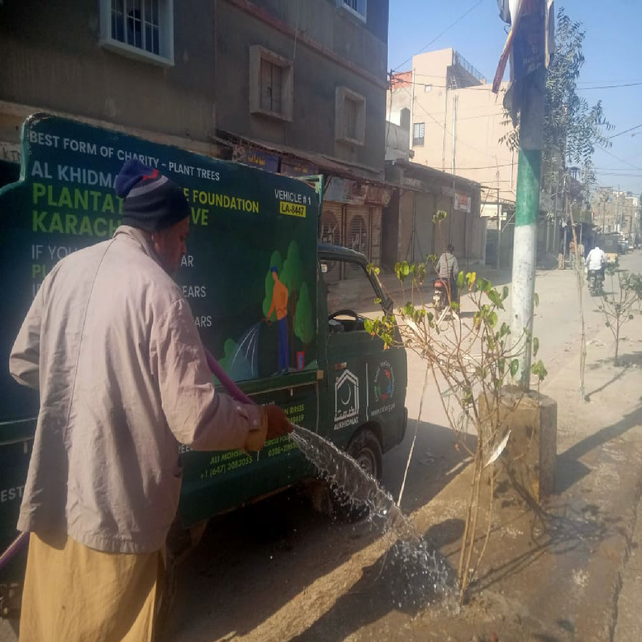 Circle Social Welfare Foundation volunteers watering trees along urban roadside as part of plantation drive and environmental sustainability initiative